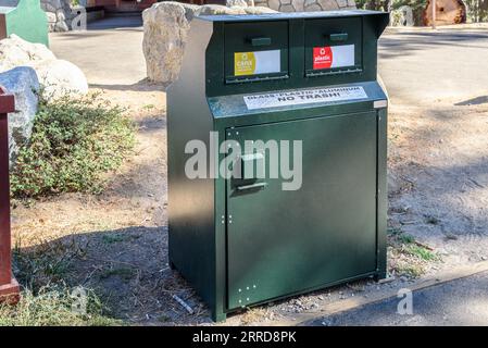 Recycling bin in a park on a sunny autumn day Stock Photo