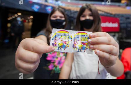 211212 -- TORONTO, Dec. 12, 2021 -- Girls pose for photos with their COVID-19 vaccination stickers after being vaccinated at a vaccination site in Toronto, Canada, on Dec. 12, 2021. The City of Toronto on Sunday hosted a superhero-themed mass vaccination event as Toronto Kids Vaccine Day to vaccinate up to 2,000 children aged five to 11 against COVID-19. Photo by /Xinhua CANADA-TORONTO-KIDS VACCINE DAY ZouxZheng PUBLICATIONxNOTxINxCHN Stock Photo