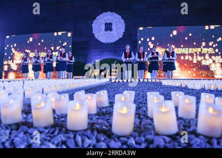 211213 -- NANJING, Dec. 13, 2021 -- Students take part in a candlelight vigil in commemoration of victims of the Nanjing Massacre on the occasion of the eighth National Memorial Day at the Memorial Hall of the Victims of the Nanjing Massacre by Japanese Invaders in Nanjing, capital of east China s Jiangsu Province, Dec. 13, 2021. The Nanjing Massacre took place after the Japanese troops captured the city on Dec. 13, 1937. Over six weeks, they killed about 300,000 Chinese civilians and unarmed soldiers in one of the most barbaric episodes of World War II.  CHINA-NANJING MASSACRE-COMMEMORATION C Stock Photo