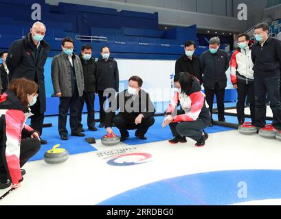 211215 -- BEIJING, Dec. 15, 2021 -- Chinese Vice Premier Han Zheng, also a member of the Standing Committee of the Political Bureau of the Communist Party of China Central Committee and head of a leading group overseeing the Beijing 2022 preparations, talks to staff while visiting the National Aquatics Center in Beijing, capital of China, Dec. 14, 2021. Han made an inspection tour of several venues in Beijing on Tuesday, including the National Speed Skating Oval, the Winter Olympic Village, the Main Media Center, the National Indoor Stadium and the National Aquatics Center.  CHINA-BEIJING-HAN Stock Photo