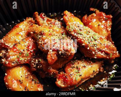 Close-up Korean Fried chicken Wings with sauce ans sesame. 치킨. Asian food. Stock Photo