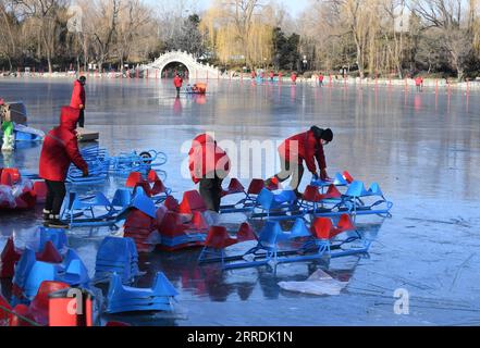 211230 -- BEIJING, Dec. 30, 2021 -- Staff members prepare sleds on a frozen lake at Yuanmingyuan Park in Beijing, capital of China, Dec. 30, 2021. The Old Summer Palace, or Yuanmingyuan, announced on Thursday that it will hold a ice and snow festival which opens around New Year s day in 2022 and lasts until February to welcome the Beijing 2022 Winter Olympic Games.  CHINA-BEIJING-YUANMINGYUAN PARK-WINTER FUN CN LuoxXiaoguang PUBLICATIONxNOTxINxCHN Stock Photo