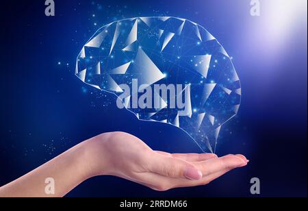 Memory. Woman holding illustration of brain against dark blue background, closeup Stock Photo