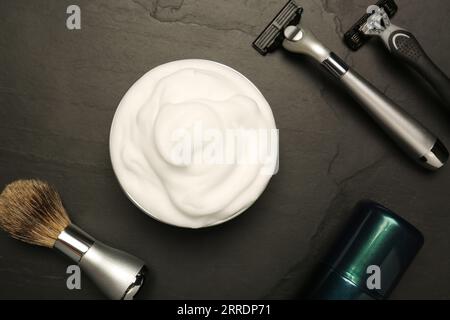 Set of men's shaving tools on black textured table, flat lay Stock Photo