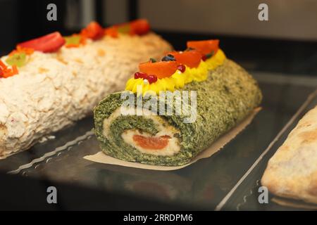 Delicious sponge cake roll on counter in store, closeup Stock Photo