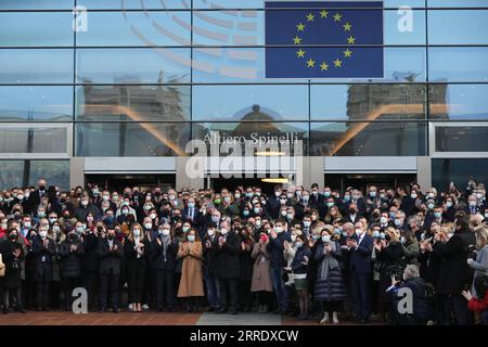 220111 -- BRUSSELS, Jan. 11, 2022 -- People react after observing a moment of silence in memory of late European Parliament President David Sassoli, in front of the European Parliament in Brussels, Belgium, Jan. 11, 2022. European Parliament President David Sassoli died at age 65 at a hospital in Italy early Tuesday, his spokesperson has said. Sassoli, born on May 30, 1956, in Florence, Italy, had been hospitalized for more than two weeks due to a serious complication relating to immune system dysfunction. Sassoli was elected to the European Parliament in 2009. He became president of the Europ Stock Photo