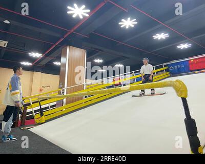 220125 -- HAIKOU, Jan. 25, 2022 -- A learner practices on an indoor artificial ski slope in Haikou, capital of south China s Hainan Province, Jan. 15, 2022. The Beijing 2022 Olympic Winter Games are scheduled from Feb. 4 to 20, followed by the Paralympics, and have stirred up passion for winter sports in China. Even people in China s warm areas, such as Hainan, have started participating in ice-snow sports. TO GO WITH China Focus: Passion for winter sports heats up on tropical island  CHINA-HAINAN-HAIKOU-WINTER SPORTS-HEAT CN ChenxZiwei PUBLICATIONxNOTxINxCHN Stock Photo