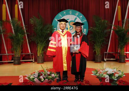 220126 -- TIANJIN, Jan. 26, 2022 -- Photo taken on July 2, 2015 shows Huang Xinyi R and Zhang Boli, then president of Tianjin University of Traditional Chinese Medicine, at a doctoral graduation ceremony of the university in north China s Tianjin. Tianjin launched its fourth citywide COVID-19 nucleic acid testing at 6 a.m. on Jan. 20. Doctor Huang Xinyi, who participated in the citywide nucleic acid testing for the second time, was in charge of the testing site of Guanyun Primary School in Hedong District of Tianjin, together with seven colleagues. Born in Kaohsiung of southeast China s Taiwan Stock Photo