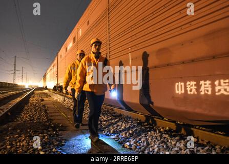 220201 -- LIUZHOU, Feb. 1, 2022 -- Staff members return from work at a railway station in Liuzhou, south China s Guagnxi Zhuang Autonomous Region, Jan. 31, 2022. On the eve of the Chinese Lunar New Year, staff members at the railway station stuck to their posts to ensure the safe operation of the trains.  CHINA-GUANGXI-LIUZHOU-FREIGHT TRAIN-MAINTENANCE CN ZhangxAilin PUBLICATIONxNOTxINxCHN Stock Photo