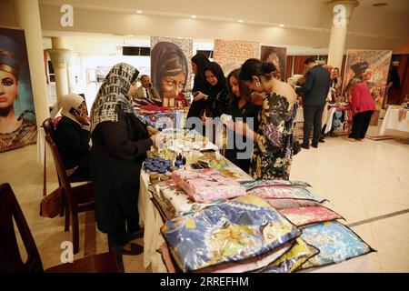 220226 -- ASWAN, Feb. 26, 2022 -- People visit handicrafts booths during a handmade products exhibition on the sidelines of a women film festival in Aswan, Egypt on Feb. 24, 2022. A variety of colorful crocheted items like teddy bears, coasters, handbags, hats, scrunchies, vases with heart-shaped flowers and much more, are displayed in a hall during a handmade products exhibition in Upper Egypt s charming city of Aswan.  EGYPT-ASWAN-HANDMADE PRODUCT EXHIBITION AhmedxGomaa PUBLICATIONxNOTxINxCHN Stock Photo