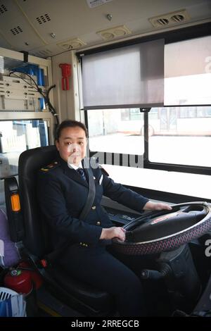 220228 -- TIANJIN, Feb. 28, 2022 -- Wang Yan poses for a photo aboard a bus in north China s Tianjin, Feb. 24, 2022. Tianjin bus driver Wang Yan is a National People s Congress NPC deputy. Since taking on her duties in 2018, Wang has continued to submit suggestions to the NPC, covering a variety of areas, such as transportation and health care. As a bus driver, she makes the most of her job, listening to her passengers opinions, while formulating suggestions that can have an influence on government policies. This year is the last year of her term of NPC deputy, Wang will put forward a suggesti Stock Photo