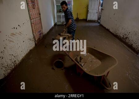 220301 -- WEST SUMATRA, March 1, 2022 -- A man cleans mud at his house after floods triggered by heavy rains and rising waters of the Batang Nango river after a 6.1-magnitude quake in Nagari Kajai village of Pasaman Barat district, West Sumatra, Indonesia, March 1, 2022. Photo by /Xinhua INDONESIA-WEST SUMATRA-FLOOD-AFTERMATH AndrixMardiansyah PUBLICATIONxNOTxINxCHN Stock Photo