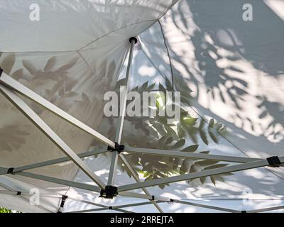 shadow of tree branches on canvas roof. leaves shadow on the tent. Stock Photo