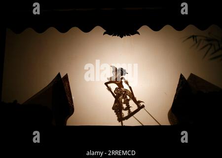 Silhouette of wayang kulit or shadow puppet Stock Photo