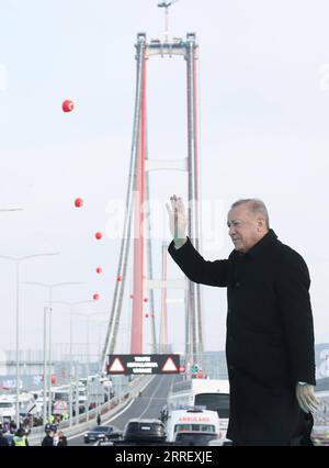 220318 -- CANAKKALE TURKEY, March 18, 2022  -- Turkish President Recep Tayyip Erdogan waves at the inauguration ceremony of the 1915 Canakkale Bridge in Canakkale, northwestern Turkey, on March 18, 2022. Turkey s 1915 Canakkale Bridge, the longest midspan suspension bridge that spans the Dardanelles Strait and connects Europe and Asia at the western end of the Marmara Sea, was inaugurated on Friday in Canakkale.  TURKEY-CANAKKALE-DARDANELLES STRAIT-BRIDGE-INAUGURATION Xinhua PUBLICATIONxNOTxINxCHN Stock Photo