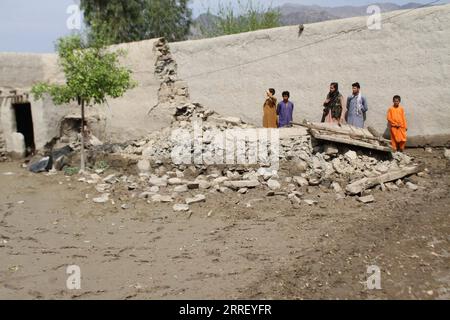 220320 -- LAL PUR AFGHANISTAN, March 20, 2022 -- People stand by a damaged wall after flash floods in Lal Pur district, Nangarhar province, Afghanistan, on March 19, 2022. Flash floods caused by heavy rain claimed two lives and destroyed hundreds of hectares of farmlands in Lal Pur district of Afghanistan s eastern Nangarhar province on Saturday, district chief Qari Abubakr said Sunday. Photo by /Xinhua AFGHANISTAN-LAL PUR-FLASH FLOODS-AFTERMATH Hamidullah PUBLICATIONxNOTxINxCHN Stock Photo