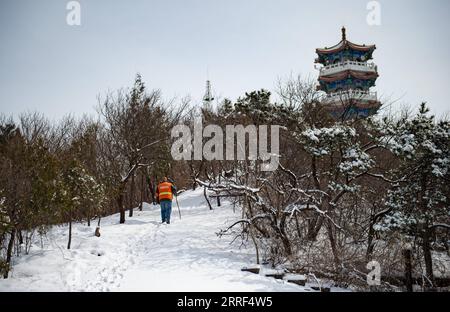 220329 -- BEIJING, March 29, 2022 -- Song Bao walks back to the watchtower on Mangshan Mountain after patrolling the forest in Beijing, capital of China, March 19, 2022. Coming from the same village in Yixian County of Baoding City in Hebei Province, Song Chen and Song Bao are currently working as forest rangers stationed at the watchtower of Mangshan Mountain in the forest adjacent to the Ming Tombs, a major tourist site in Beijing s suburb. The two forest rangers, grown up as childhood friends, are now work partners since they landed on this job a few years ago. They are collaboratively resp Stock Photo