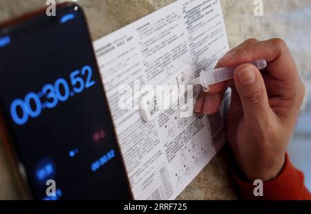 220402 -- BEIJING, April 2, 2022 -- A resident takes rapid antigen test for COVID-19 in east China s Shanghai, March 26, 2022.  Xinhua Headlines: In-depth explainer of China s dynamic zero-COVID policy RenxLong PUBLICATIONxNOTxINxCHN Stock Photo