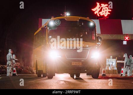 220408 -- CHANGCHUN, April 8, 2022 -- A school bus transporting supportive team members comes back from Changchun to Meihekou City, northeast China s Jilin Province, April 3, 2022. Some 5,000 supportive staff from Meihekou City who are aiding Changchun, one of the hardest-hit cities in China amid the latest virus resurgence, commute between the two cities every day in order to lessen boarding and lodging burdens on Changchun. The supportive team members, including medics, government officials and police officers, start off early morning and get back in late night, both by taking ferry buses. T Stock Photo