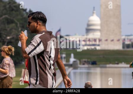 Washington, USA. 8th Sep, 2023. A tourist drinks water at the National Mall during a heatwave in Washington, DC, the United States, Sept. 7, 2023. Credit: Aaron Schwartz/Xinhua/Alamy Live News Stock Photo