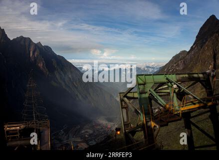 The massive infrastructure from above the mill with a view of the cable car equipment surrounded by mountains Stock Photo