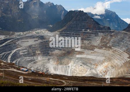 The massive Grasberg open pit mine from an airial view Stock Photo