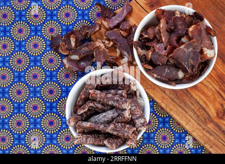 South African Traditional Biltong and dry wors on blue traditional printed cloth. Stock Photo