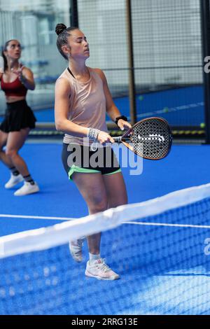 Young Girls Who Is Playing Padel on an Indoor Court. Stock Photo