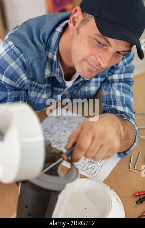 professional young worker fixing coffee machine Stock Photo