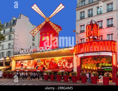 Moulin Rouge cabaret theatre at dusk, Place Blanche, Boulevard de Clichy, Pigalle District, Paris, Île-de-France, France Stock Photo