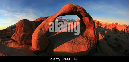 Whitney Arch with Mount Whitney and Lone Pine Peak seen through the center of the arch in the Alabama Hills, California. Stock Photo