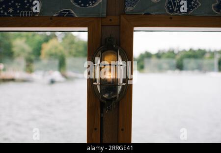 glowing light on a ferry boat at sea Stock Photo