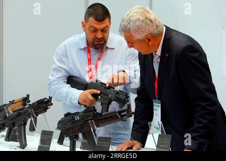 220518 -- BUCHAREST, May 18, 2022 -- An exhibitor talks with a visitor at the Black Sea Defense and Aerospace Exhibition in Bucharest, capital of Romania, on May 18, 2022. Photo by /Xinhua ROMANIA-BUCHAREST-BSDA EXHIBITION CristianxCristel PUBLICATIONxNOTxINxCHN Stock Photo