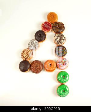Number four formation with many brioche colourful doughnuts. Stock Photo