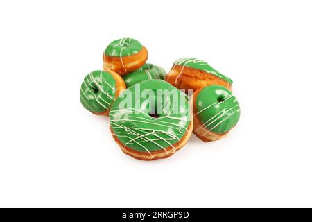 Green coloured large and mini doughnuts with white icing for special occasions. Stock Photo