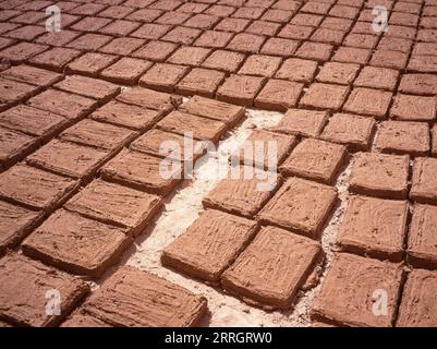 Straw reinforced mud bricks drying in the sun for construction purposes in Yemen Stock Photo