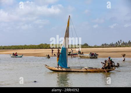 Morondava, Madagascar - November 3rd 2022: A fisherman sails back from the sea to the river on a sailboat in Morondava Stock Photo