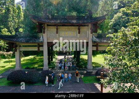 220608 -- WUYISHAN, June 8, 2022 -- Aerial photo taken on June 6, 2022 shows tourists visiting a park dedicated to Zhu Xi, a renowned Chinese philosopher in the 12th century, in Mount Wuyi in southeast China s Fujian Province. Mount Wuyi, located in China s southeast province of Fujian, is a landscape of great beauty, in which the peaks and rocks of grotesque shapes are girded by clear streams and embraced by green trees and bamboo plants. Acting as a habitat for a large number of wildlife, it is of enormous importance for biodiversity conservation. There are a series of exceptional archaeolog Stock Photo