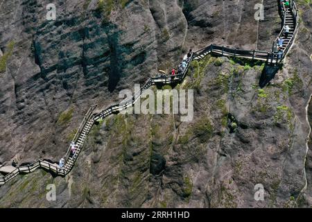 220608 -- WUYISHAN, June 8, 2022 -- Aerial photo taken on June 6, 2022 shows tourists visiting Mount Wuyi in southeast China s Fujian Province. Mount Wuyi, located in China s southeast province of Fujian, is a landscape of great beauty, in which the peaks and rocks of grotesque shapes are girded by clear streams and embraced by green trees and bamboo plants. Acting as a habitat for a large number of wildlife, it is of enormous importance for biodiversity conservation. There are a series of exceptional archaeological sites at Mount Wuyi, including the remains of ancient Han Dynasty 202 BC-220 A Stock Photo