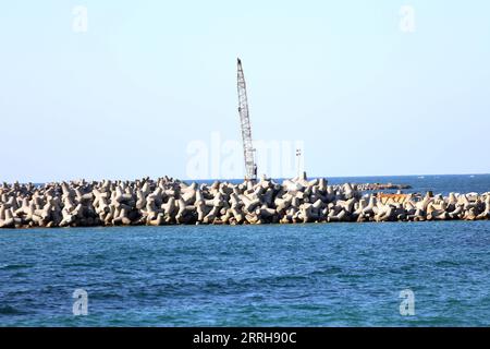 220620 -- ALEXANDRIA, June 20, 2022 -- Concrete barriers used against sea-level rises are seen along the coastline in Alexandria, Egypt, June 19, 2022. The Egyptian Ministry of Water Resources and Irrigation has launched a climate adaptation project on the North Coast and the Nile Delta to counter sea-level rises, the impact of weather hazards on low-lying coastal areas, and seawater intrusion.  EGYPT-ALEXANDRIA-CLIMATE CHANGE-RISING SEA LEVEL-COASTAL CONCRETE BARRIER AhmedxGomaa PUBLICATIONxNOTxINxCHN Stock Photo