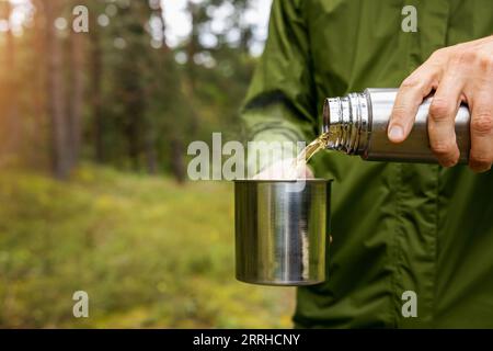 Thermos camping. Thermos for tourism. Thermos in nature Stock