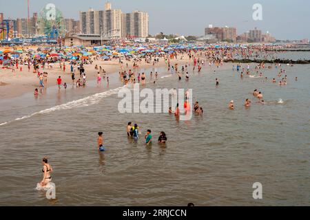 Beachgoers flock to Coney Island in Brooklyn in New York on the unoffical end of summer, Labor Day, Monday, September 4, 2023. Visitors mobbed the beach and the surf on the humid holiday.  (© Richard B. Levine) Stock Photo