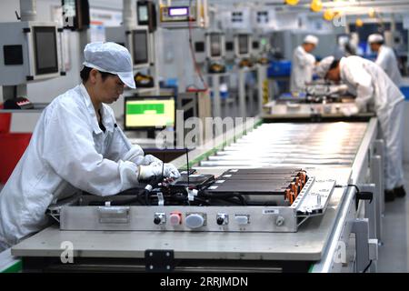 220730 -- HEFEI, July 30, 2022 -- Workers work on a power battery production line at a workshop of a battery production company in Hefei Economic and Technological Development Area in Hefei, east China s Anhui Province, July 29, 2022. In recent years, Hefei has promoted the power battery industry, a crucial part of new-energy vehicles industry, by developing and introducing power battery production companies. Photo by /Xinhua CHINA-ANHUI-HEFEI-POWER BATTERY INDUSTRY CN WuxXiaoli PUBLICATIONxNOTxINxCHN Stock Photo