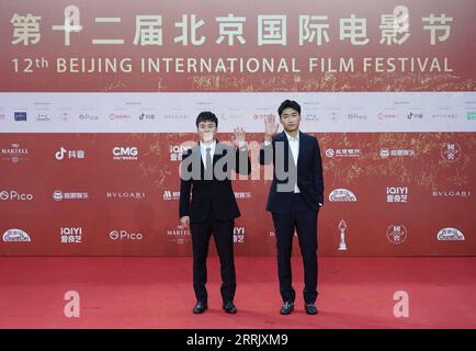 220813 -- BEIJING, Aug. 13, 2022 -- Gao Tingyu R and Qi Guangpu, gold medalists of Beijing 2022 Winter Olympic Games, pose for a photo on the red carpet of the 12th Beijing International Film Festival in Beijing, capital of China, Aug. 12, 2022.  CHINA-BEIJING-INTERNATIONAL FILM FESTIVAL-RED CARPET CN ChenxZhonghao PUBLICATIONxNOTxINxCHN Stock Photo