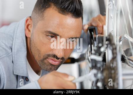 man fixing pedals on a bicycle Stock Photo