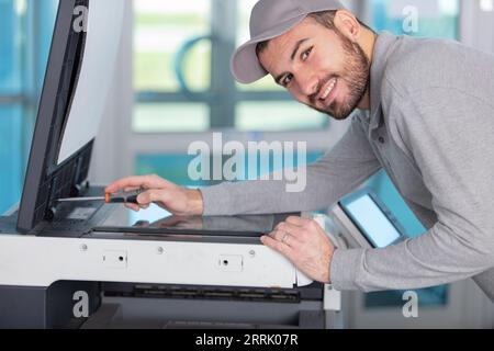 trying to repair the office printer Stock Photo