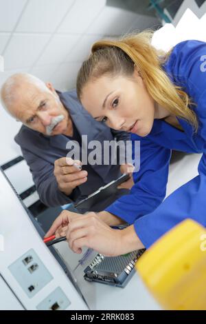 technician using multimeter to test appliance Stock Photo