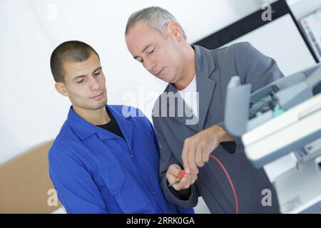 portrait of technician fixing cables Stock Photo