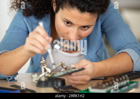 engineer woman repairs laptop support fixing notebook computer Stock Photo