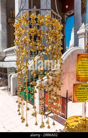 Gold colored wishing bells, Buddhist temple complex Wat Intharawihan, Bangkok, Thailand, Asia Stock Photo